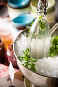 a glass bottle filled with ice and green herbs at Hotel Daniel Vienna - Smart Lifestyle Near City Centre in Vienna