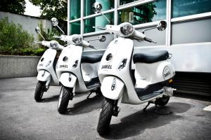 two white scooters parked in front of a building at Hotel Daniel Vienna - Smart Lifestyle Near City Centre in Vienna