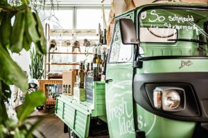 a green food truck parked in a store at Hotel Daniel Vienna - Smart Lifestyle Near City Centre in Vienna