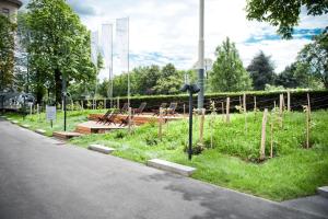 a park with benches and tables on the side of a road at Hotel Daniel Vienna - Smart Lifestyle Near City Centre in Vienna