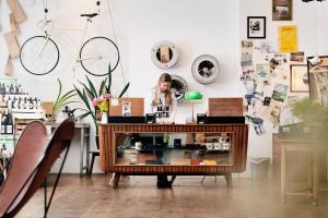 a woman standing behind a counter in a room at Hotel Daniel Vienna - Smart Lifestyle Near City Centre in Vienna