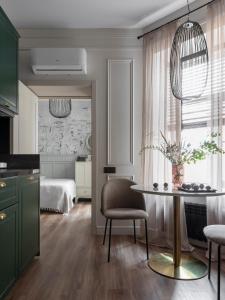 een keuken en een woonkamer met een tafel en een bed bij Hotel Point by Academia in Sint-Petersburg