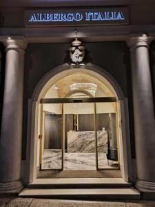 an entrance to a building with a glass door at Albergo Italia in Matera