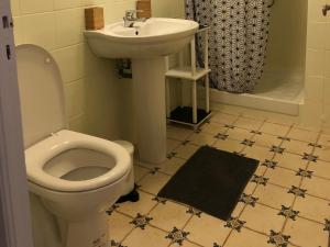 a bathroom with a toilet and a sink at Appartement Casella in Bastia