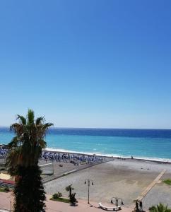 a beach with a lot of people and the ocean at Casalmare Sabina in Ventimiglia
