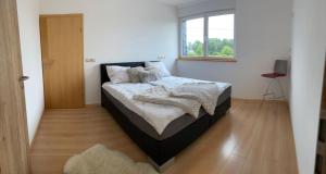 a bedroom with a bed in a room with a window at Residenz Arens in Amblève