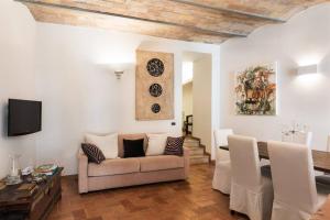 a living room with a couch and a table at Idyllia - lovely Colosseum loft apartment in Rome