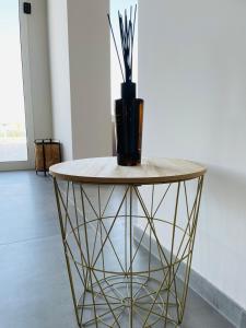 a table with a vase on top of it at Hotel VIU57 in Mellieħa