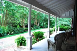 a screened porch with a view of a garden at Glenfield Plantation Historic Antebellum Bed and Breakfast in Natchez