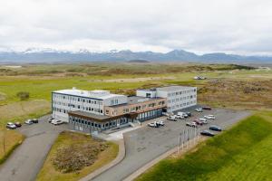 an aerial view of a building with cars parked in a parking lot at Fosshotel Stykkisholmur in Stykkishólmur