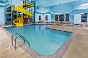 a pool with a slide in a building at Super 8 by Wyndham Central Pt Medford in Central Point