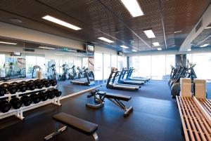 a gym with a lot of treadmills and machines at Wyndham Resort Torquay in Torquay