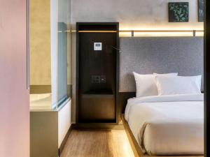 Cama ou camas em um quarto em Novotel BH Savassi