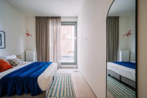 A bed or beds in a room at Smartflats - River View Ghent