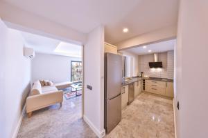 a kitchen with a stainless steel refrigerator and a living room at Sole Suites in Kas