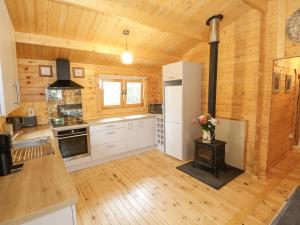 a large kitchen with wooden walls and wooden floors at Port Heron Lodge in Athlone