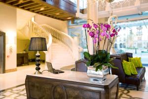 a living room with a vase of flowers on the table at Pivot Hotel Montecasino in Johannesburg
