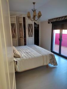 a bedroom with a bed and a large window at Casa Marina in Ribeira