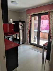 a kitchen with a sliding glass door to a patio at Casa Marina in Ribeira