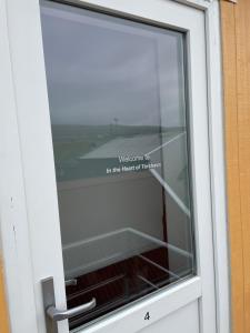 a window with a sign that readswelcome to in the heart of respondent at In the heart of Tórshavn in Tórshavn