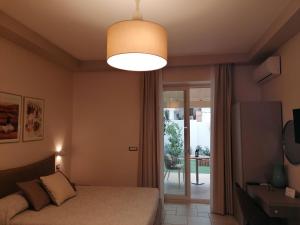 a bedroom with a bed and a large light fixture at Lux Suite in Taranto
