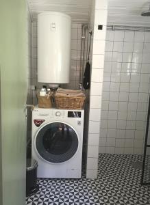 a washer and dryer in a small room with at Smedjan cottage in Enköping