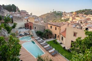 a villa with a swimming pool and a city at Gratteri Resort in Gratteri
