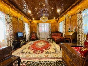 a living room with a couch and a piano at Dilshad Houseboats in Srinagar