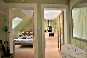 a room with a bedroom with a bed and a mirror at King Street Apartment in Inverness