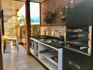 a kitchen with a sink and a counter top at EccO Capricornio in Caraguatatuba