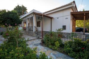 a house with a garden in front of it at KERASIA'S COUNTRY HOUSE in Volos