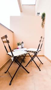 a table and two chairs in a room at Nordik Rooms Village - Chilches "Taby" in Vélez-Málaga