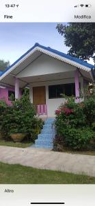 a house with a pink door and some bushes at The Mountain View Hat Sai Ri Resort in Chumphon