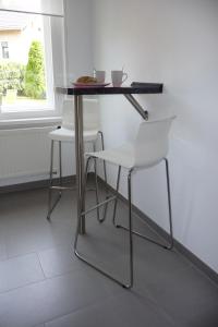 a table and chairs in a room with a window at Quartier an der Elbe in Dresden