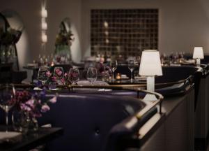 a dining room with wine glasses on a table at One Aldwych in London