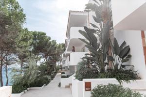 a large white building with a large window at Inturotel Cala Azul in Cala d´Or