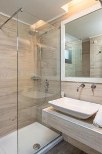 a bathroom with a sink and a glass shower at Mary's Luxury in Chrysi Ammoudia