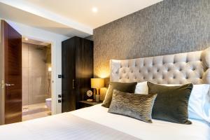 a bedroom with a large bed with a large headboard at Piccadilly Place in York