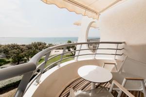 a balcony with a view of the beach at Hôtel Les Corallines - Thalasso & Resort in La Grande Motte