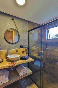 a bathroom with a sink and a shower at DOM Hotel Boutique in Campos do Jordão