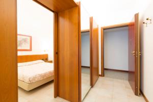 a bedroom with a door leading to a bed at Residence Donatello in Milan