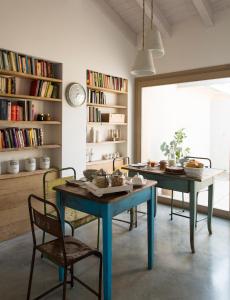 a dining room with a blue table and chairs at A Casa Di Ita in Villorba