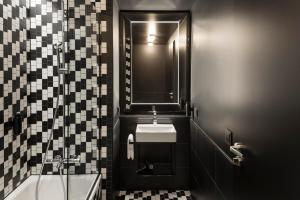 a bathroom with a sink and a mirror at Hotel AMANO East Side in Berlin +46 photos