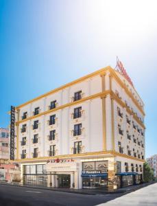 a large white building on the corner of a street at TAMARA Business Otel in Antalya