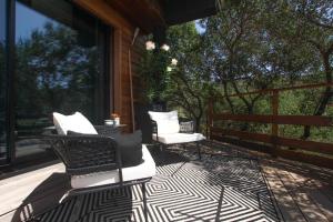 a screened in porch with two chairs and a table at Chambre d'hôtes A Vadina Porticcio in Porticcio