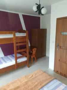 a bedroom with two bunk beds and a door at Ośrodek Agroturystyka "u Chlipały" in Ochotnica Górna