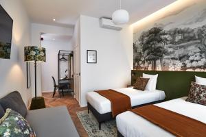 Postel nebo postele na pokoji v ubytování Urban Yard Hotel