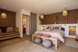 a bedroom with a large bed and a couch at Chambre d'hôtes A Vadina Porticcio in Porticcio +37 photos