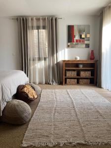 a bedroom with a bed and a window with curtains at Chambre d'hôtes A Vadina Porticcio in Porticcio