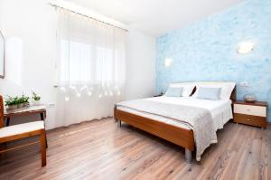Postel nebo postele na pokoji v ubytování Apartment Casa Banko